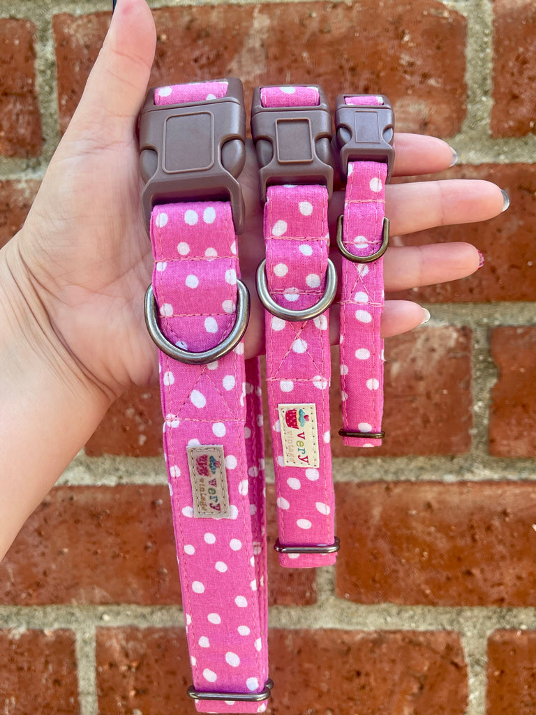 Handmade pink collar with white polka dots on vintage brick wall, featuring antique brass and antique  silver hardware