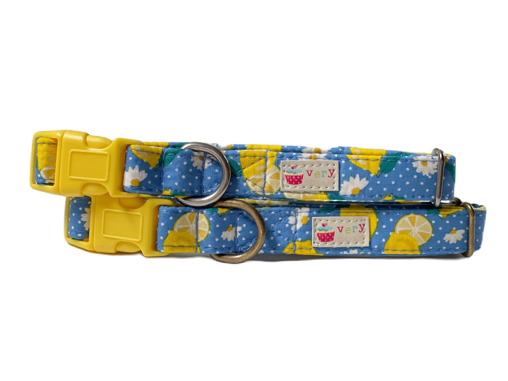 A closeup of the dog and cat collar with the same playful pattern of blue cotton, white polka dots, yellow lemons, and white daisies, emphasizing the full look of this cheerful, girly design.