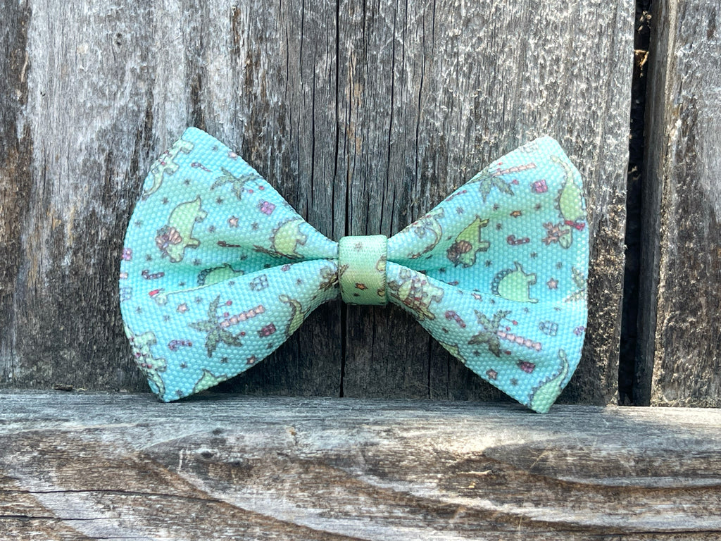 mint green with fun and festive holiday dinosaurs dog bowtie with easy and secure elastic attachment