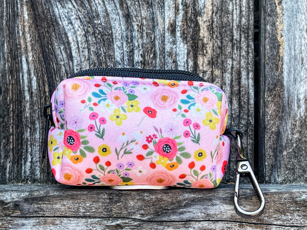 light pink with colorful flowers like rifle paper co flowers dog poop bag holder