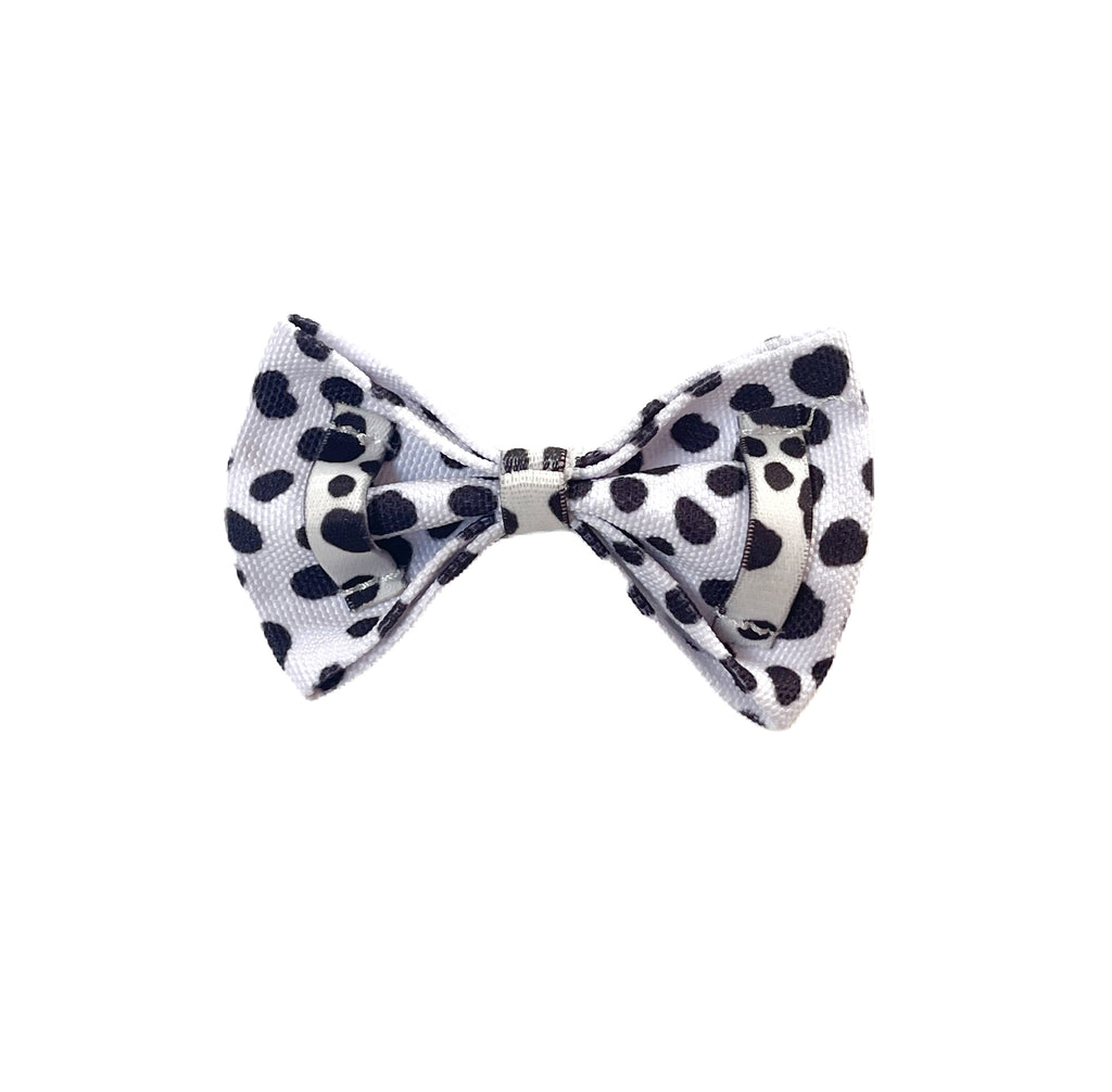 back of cow print bowtie with two elastic loops on the back for easy collar attachment