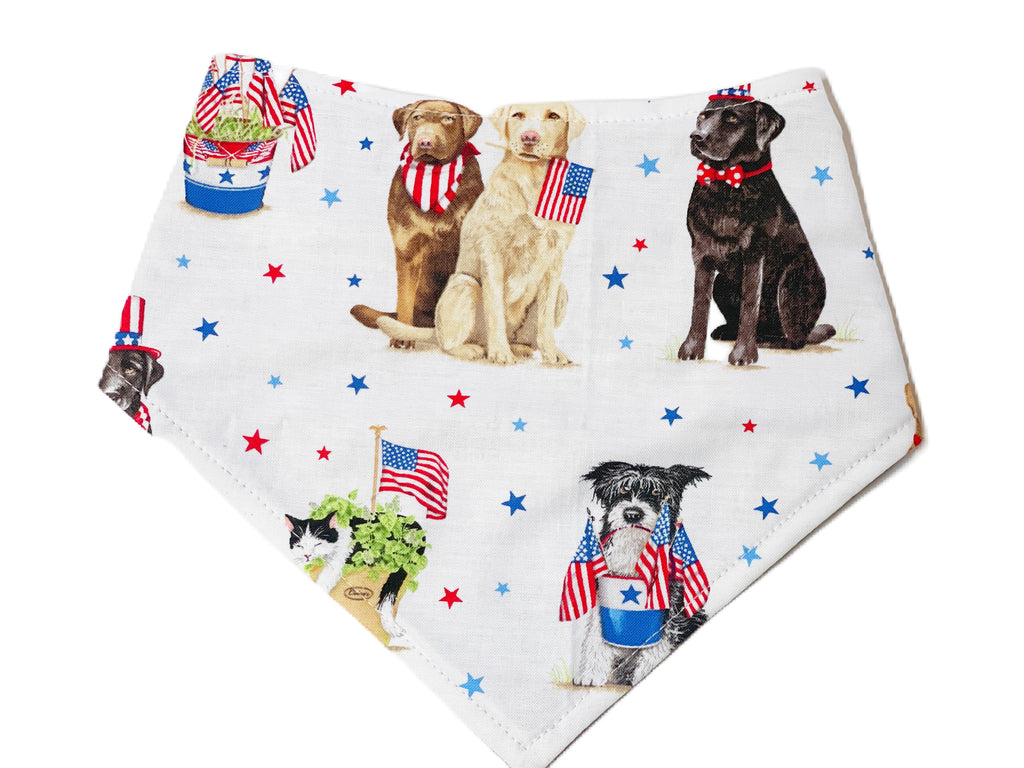 Handmade organic cotton dog bandana in white, featuring a variety of patriotic dogs with red and blue stars. Perfect for celebrating Independence Day.