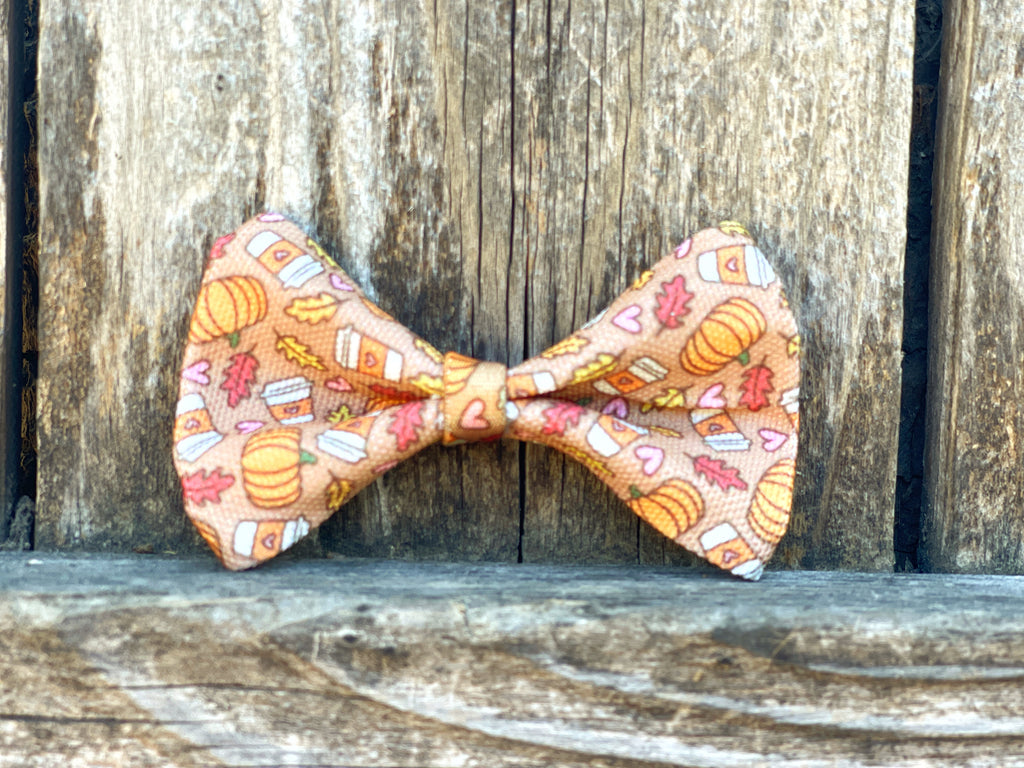 handmade light brown autumn themed heavy duty canvas dog bowtie with pumpkins, lattes, and fall leaves.