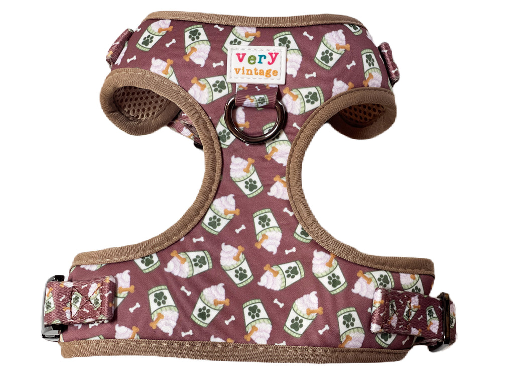 Adjustable dog harness with soft, comfortable padding and a secure buckle closure. Features a stylish chocolate brown pattern with coffee latte designs. Perfect for small, medium, and large dogs.