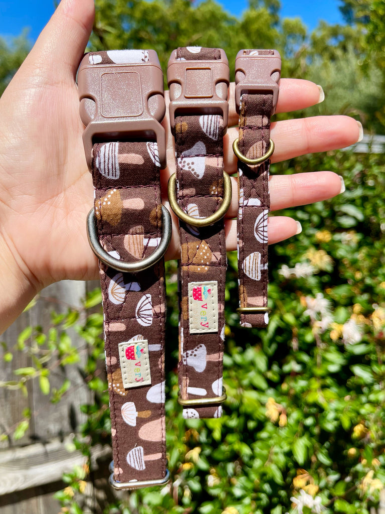 A variety of sizes of the mushroom collar, displayed outdoors to highlight the earthy colors and whimsical design in natural light. Featuring antique brass or antique silver hardware, this collar is perfect for fans of Alice in Wonderland and fairy tale charm.