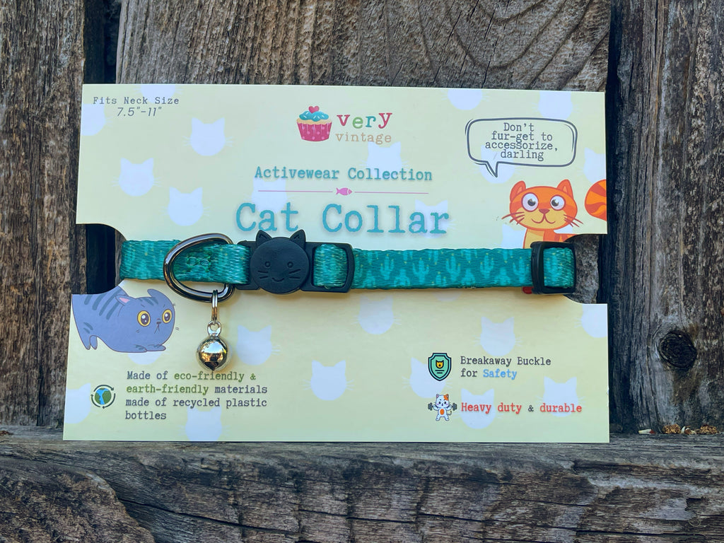 Green nylon cat collar with playful cactus design, packaged for gift-giving.