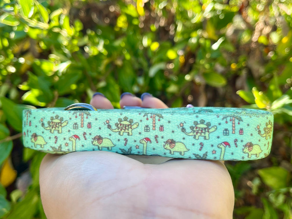 Mint green dinosaur print leash showing candy canes and stars with sleek hardware