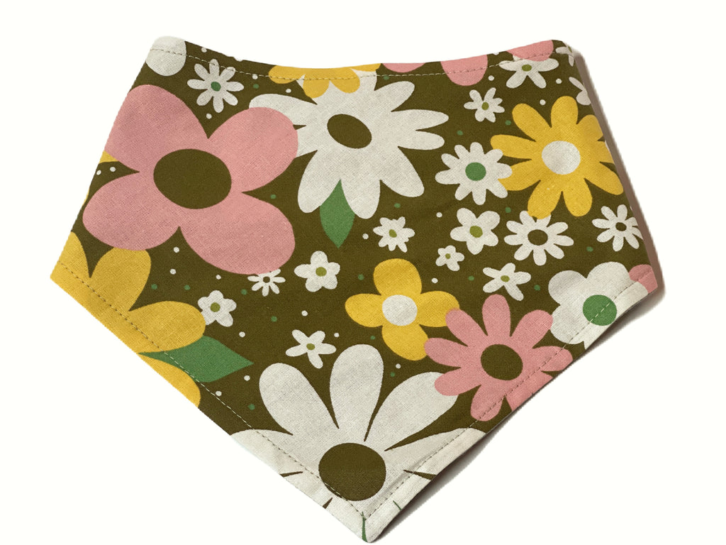 Dog bandana with an olive green background featuring a vibrant 70s-inspired floral pattern in white, yellow, and pink. Handmade in Los Angeles.