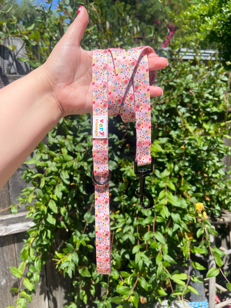 Super fun pink flower dog leash that matches the harness and poop bag