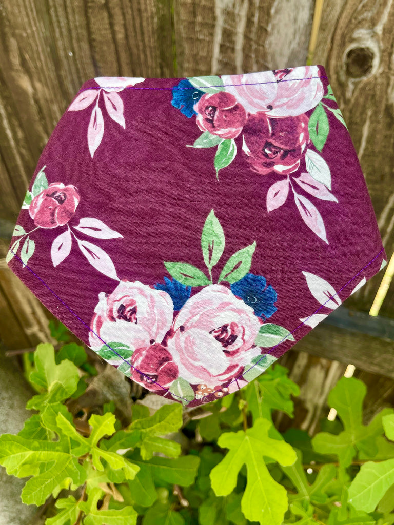 The Gatsby floral bandana laid flat to show rose pattern in pink, burgundy, and green on deep plum cotton fabric