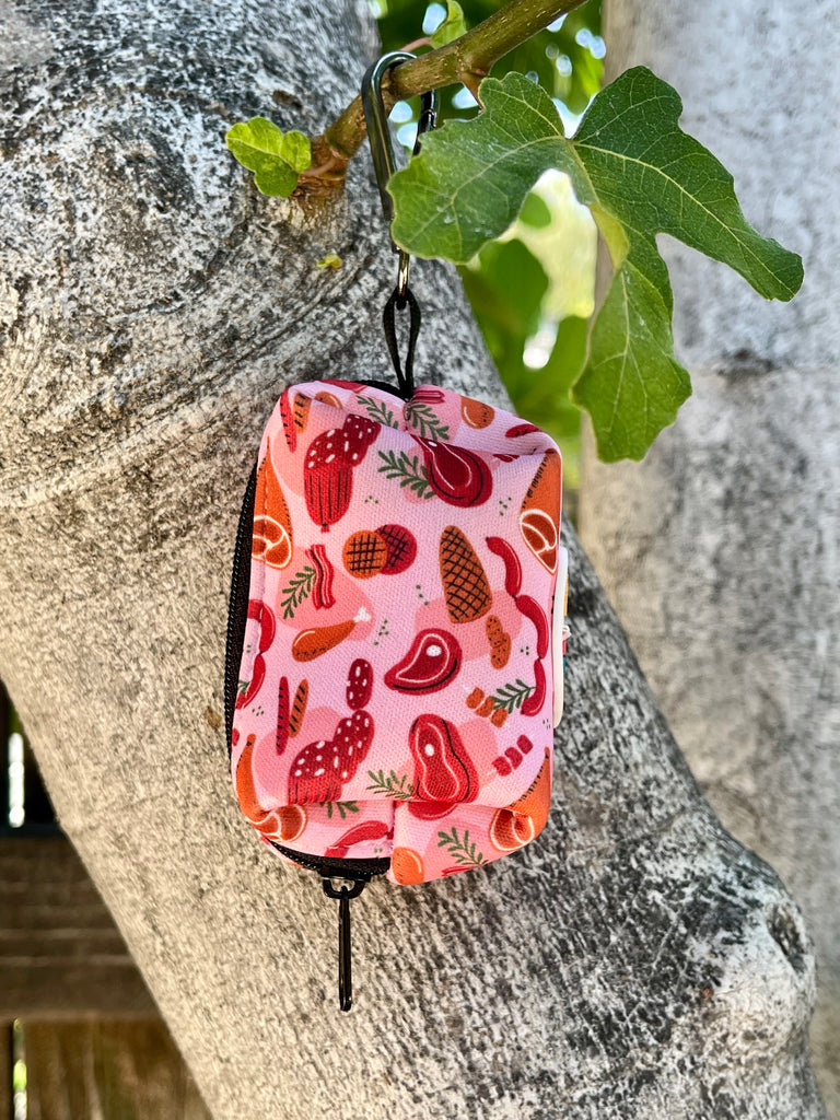 Red and pink butcher-themed poop bag dispenser with easy-access opening.