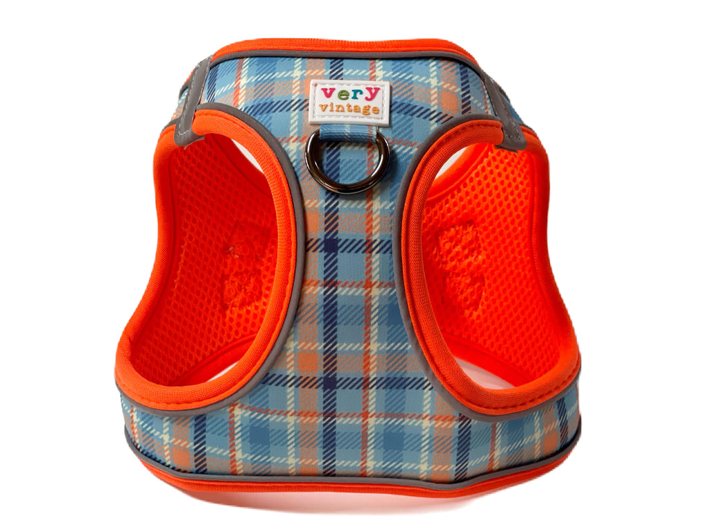 Stylish plaid step-in dog harness vest for small breed puppies. Featuring light blue, cream, navy blue, and orange colors, this harness offers padded comfort and reflective strips for added safety.