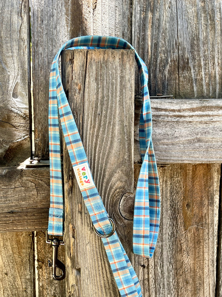 Durable, eco-friendly plaid dog leash in light blue, orange, navy, and white.