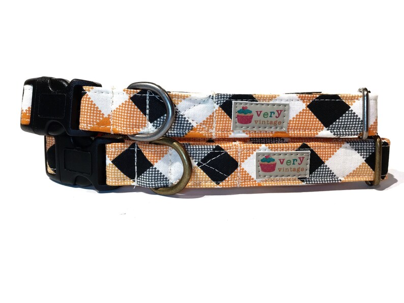 A handmade organic cotton dog collar with a vibrant orange, black, and cream plaid pattern. Choose from antique brass or antique silver hardware. Made in Los Angeles.