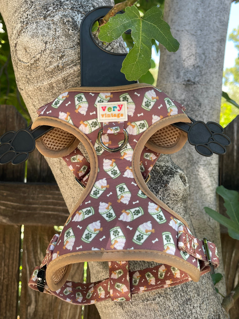 brown with white and green paw print pup cups dog harness vest with adjustable straps, metal buckle and hardware.