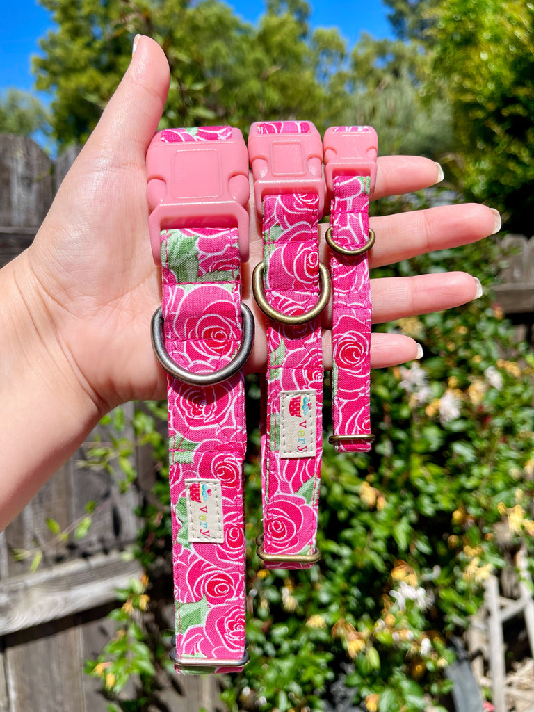 Handmade organic cotton dog collar with a hot pink background and large cabbage roses in rich pink, red, and green hues, perfect for a sunny day stroll. Available in custom sizes for dogs and cats, with antique brass or silver hardware and a breakaway buckle for cats.