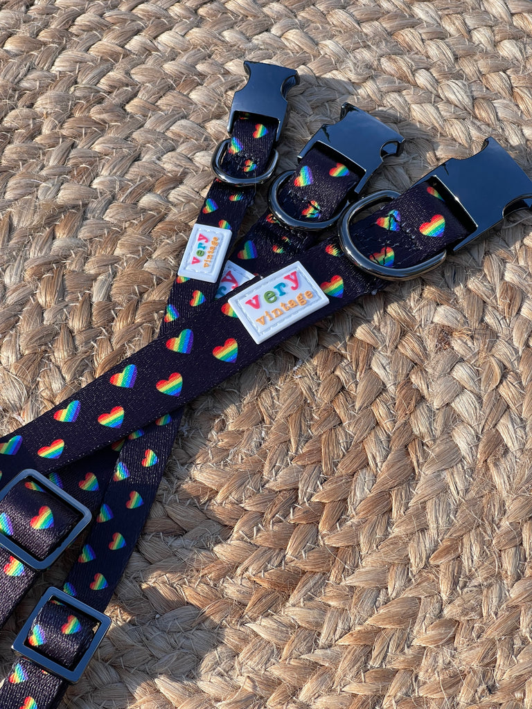 stylized shot of the rainbow heart dog collars available in the three different sizes - small, medium, large