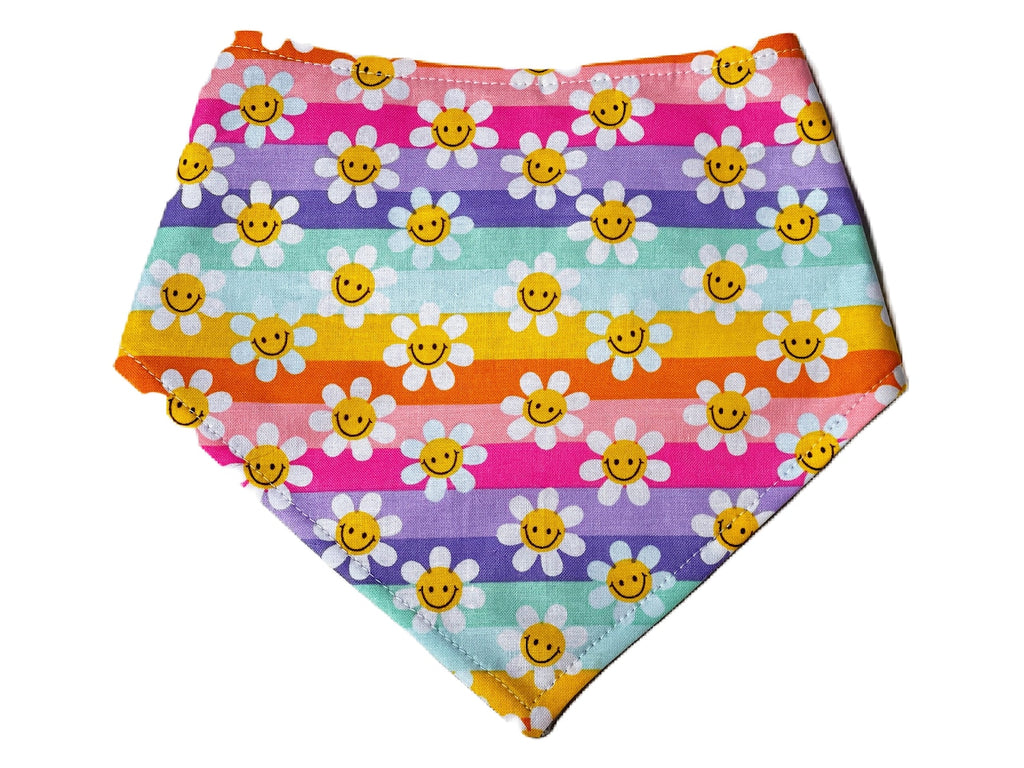 bright rainbow striped with white daisies with a yellow happy face pattern snap on pet bandana that is handmade in the USA. It is a soft cotton and 3 snaps for a secure fit.