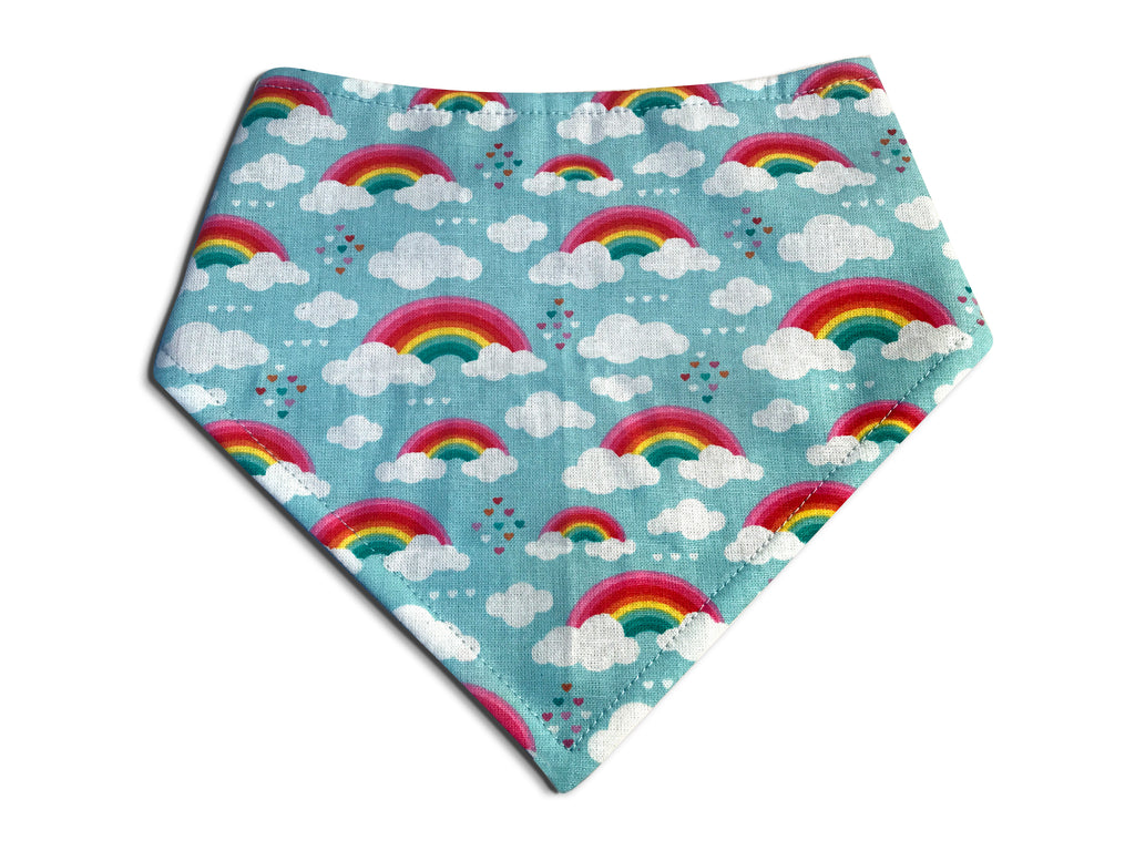 Handmade in Los Angeles. This organic cotton dog and cat bandana has a light blue with white clouds and bright rainbows pattern. It also has 3 snaps for an adjustable and secure fit.