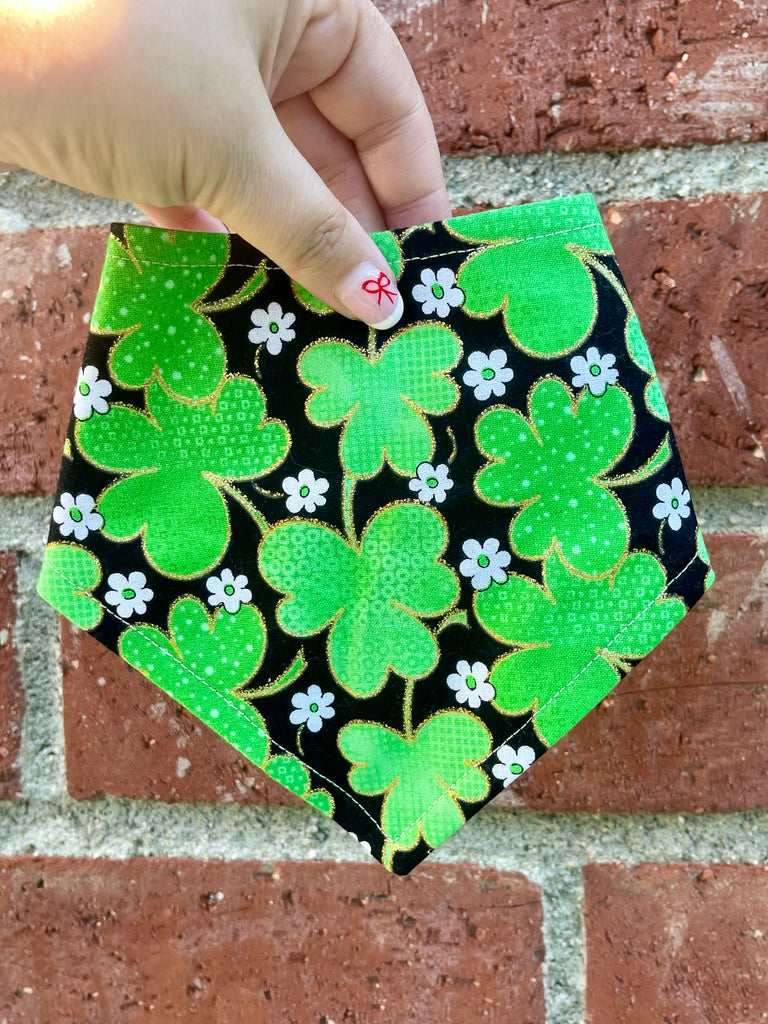 St. Patrick’s Day dog bandana featuring bright green shamrocks on black background