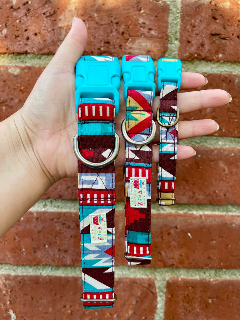 Eco-friendly southwestern-style dog collar with bold pattern and earthy tones, displayed against a brick wall. Handmade and adjustable with vintage hardware. Cat collars come with breakaway buckles for safety.