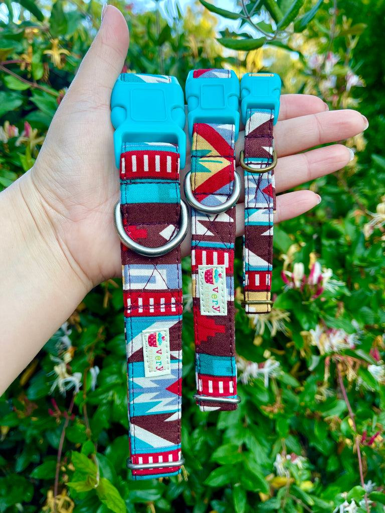 Handmade boho dog collar with geometric rust and gold pattern, shown outdoors in a garden. Organic cotton with antique brass or antique silver hardware and turquoise buckle.