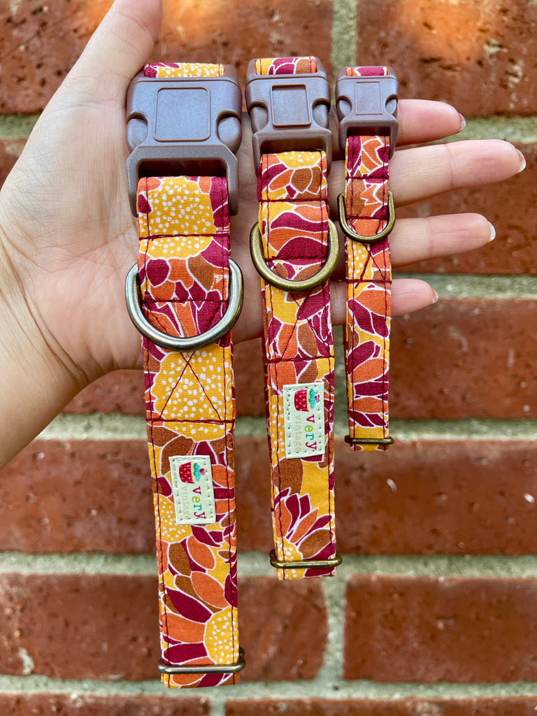 Eco-friendly floral dog collar in golden mustard yellow with sunflower design, shown against a vintage brick wall. Adjustable, handmade, and sustainable.