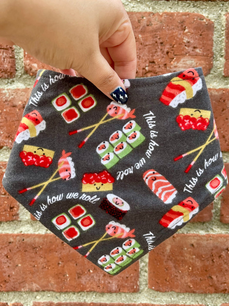 Kawaii sushi dog bandana with smiling sushi rolls and chopsticks on dark gray background