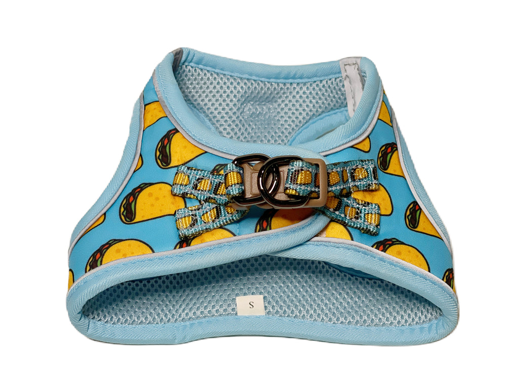 Close-up of the back of a taco print dog harness, showing the secure closure and reflective details