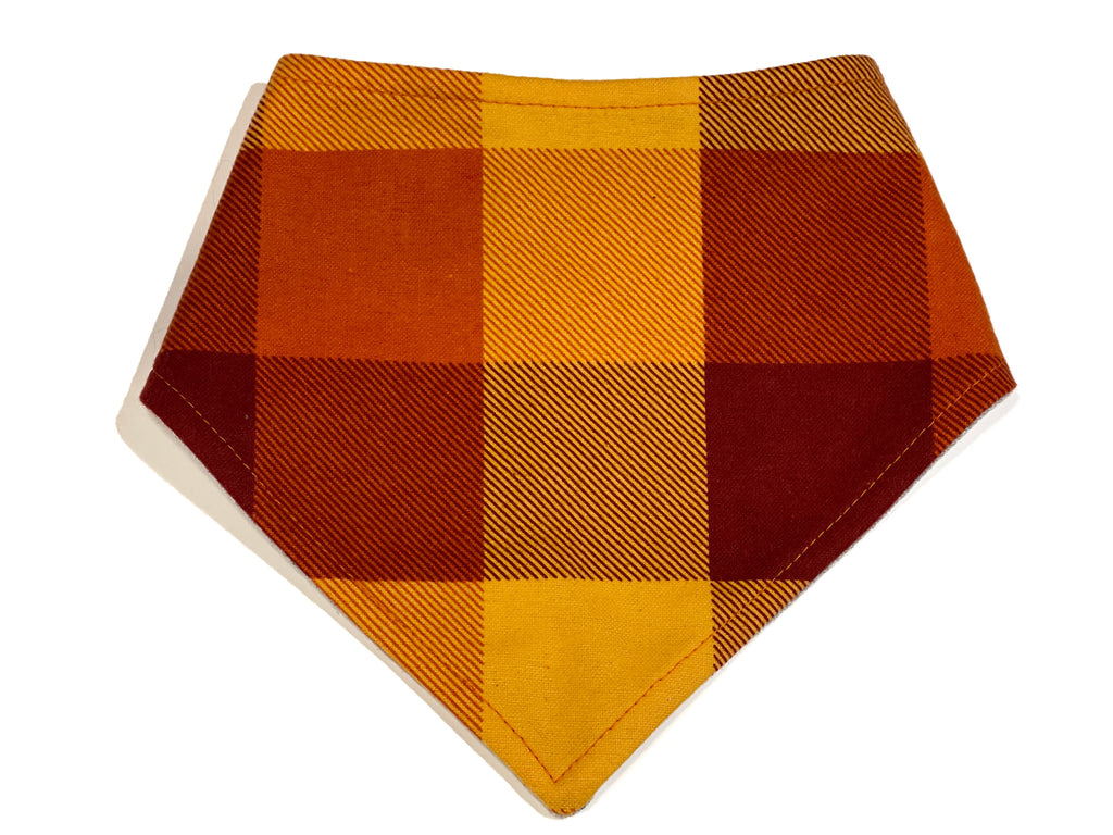 Handmade Harvest Plaid snap-on bandana for dogs and cats, featuring a yellow and rust buffalo plaid pattern, made from soft flannel with an eco-friendly organic cotton backing and adjustable fit.