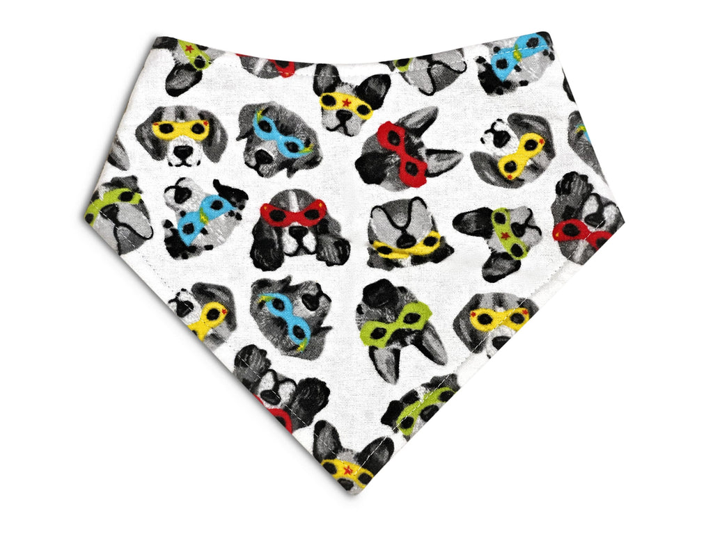 Handmade in Los Angeles. A dog bandana in a white background with super hero dogs with masks. 3 snaps on the back for a secure and adjustable fit. 