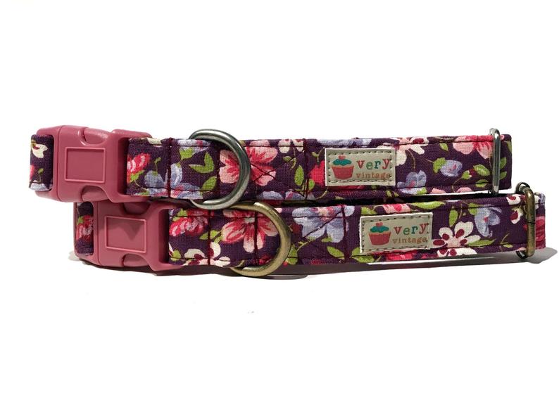 Handmade organic cotton dog collar with African violet floral pattern, featuring purple and pink flowers on a dark purple background. Available in various sizes for dogs and cats, with optional antique brass or antique silver hardware. Breakaway buckle available for cat safety.