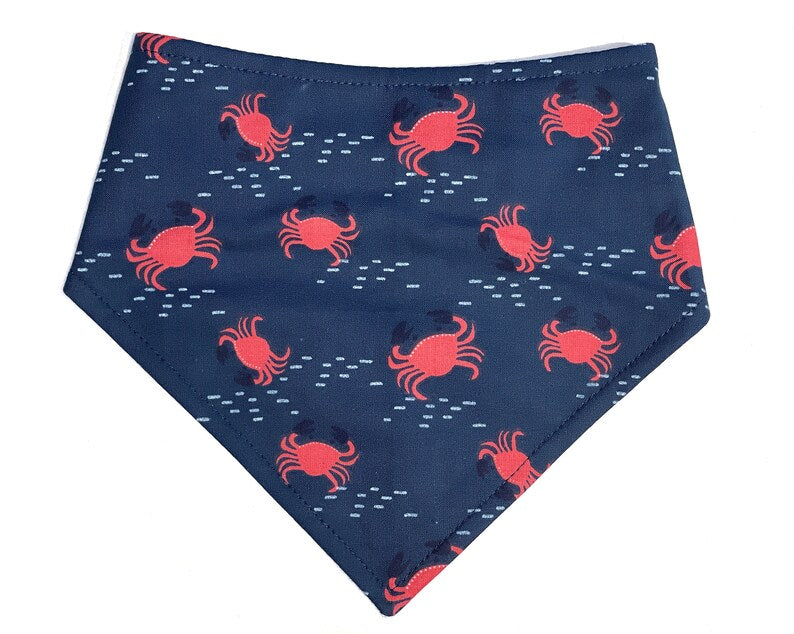 Nautical-themed dog bandana in navy blue with red crab print.