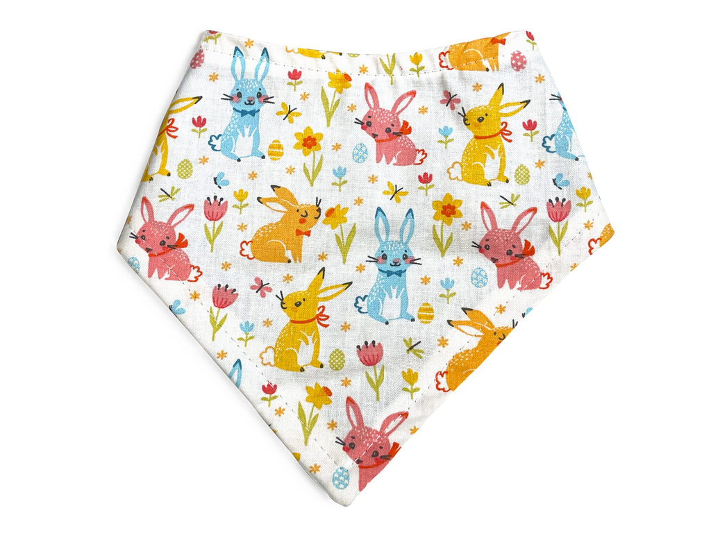 Handmade in Los Angeles. White with blue, orange, and dark pink bunnies and flowers and easter eggs. 3 snaps on the back for a secure and adjustable fit.