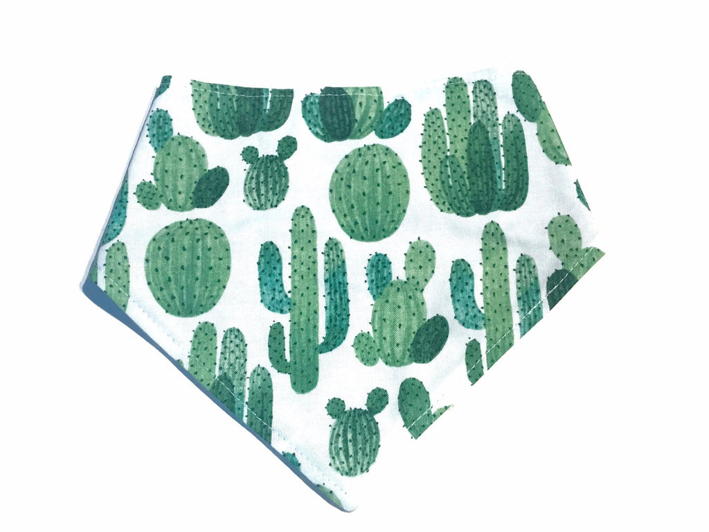 Cute and functional dog bandana featuring a cactus design. Made from soft, organic cotton and adjustable with three snaps.