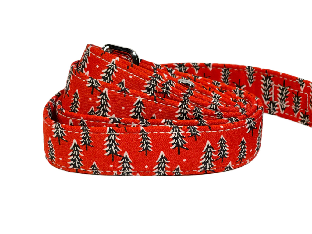 red with green pine trees with a bit of snow on them. Heavy duty hardware for the leash. Handmade in the USA.