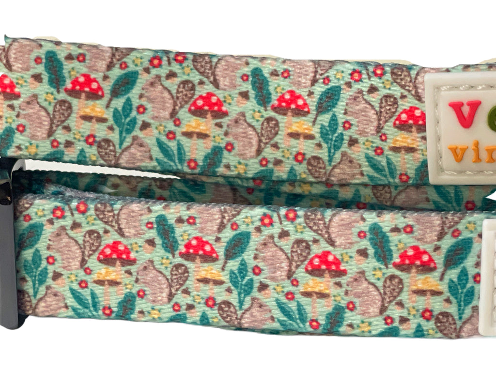 closeup of lightweight mint green dog collar with a comfortable fit and a charming squirrel and mushroom design.