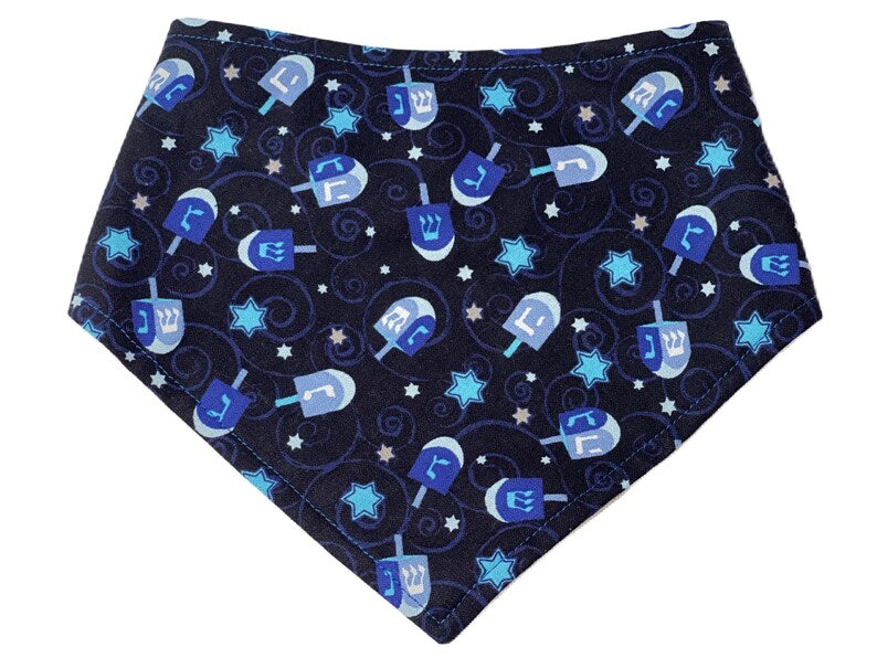 Navy blue dog and cat bandana with a festive Hanukkah pattern featuring dreidels and Jewish stars.