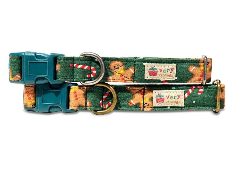 Hunter green dog and cat collar featuring a festive pattern of gingerbread cookies, red and white candy canes, and holiday cheer. Made from organic cotton, with durable hardware perfect for Christmas and winter-themed adventures.