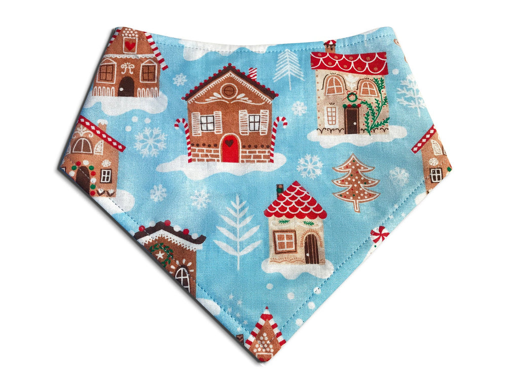 Handmade light blue bandana featuring a whimsical gingerbread house pattern, perfect for the holidays and Christmas, for dogs and cats.