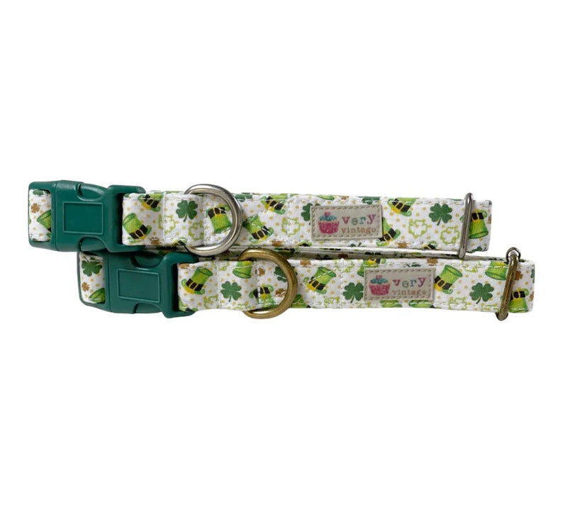 A close-up image of a dog collar with a white background, gold dots, leprechaun hats, and shamrocks, showcasing the festive St. Patrick's Day design. Handmade in Los Angeles.