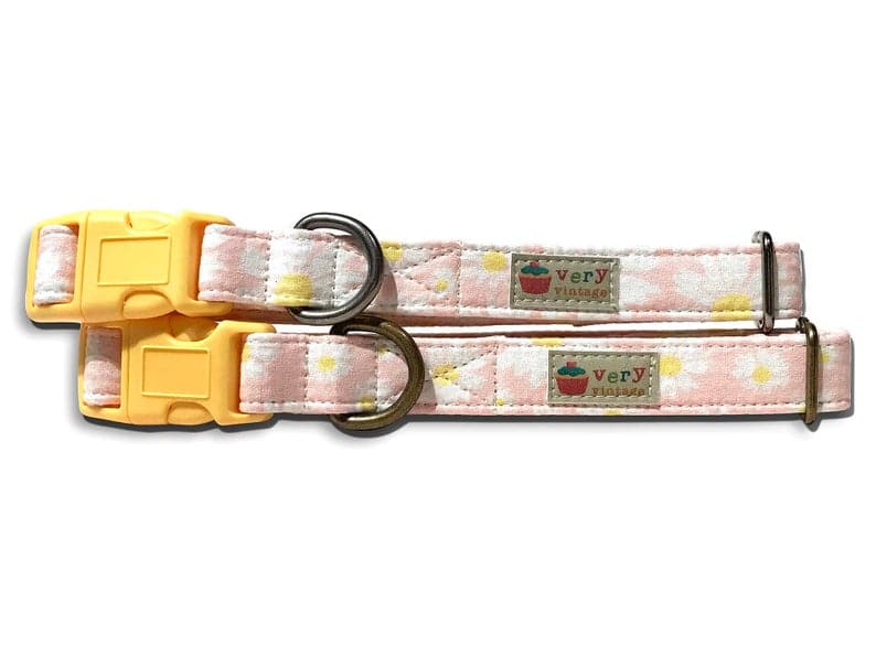 A close-up of the light pink collar with white daisies, showcasing the soft, floral design. Available with antique brass or antique silver hardware, this collar adds a feminine, springtime touch to your pet’s look. Cat collars come with breakaway buckles.