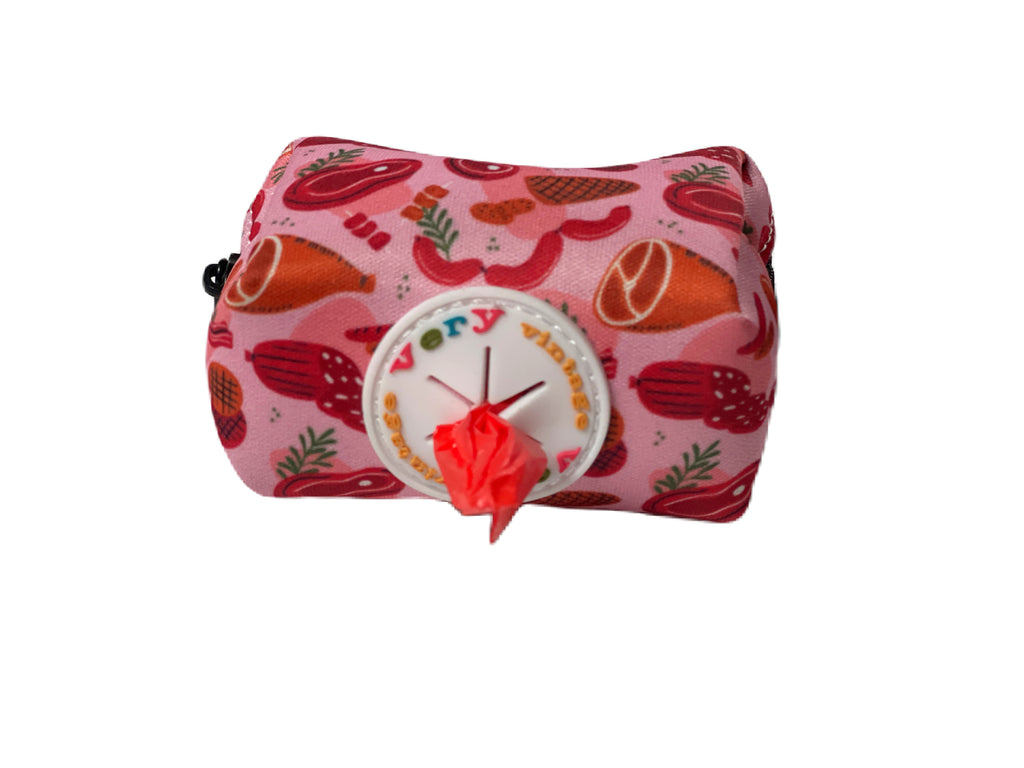 Stylish reddish-pink dog waste bag dispenser featuring a butcher shop pattern.