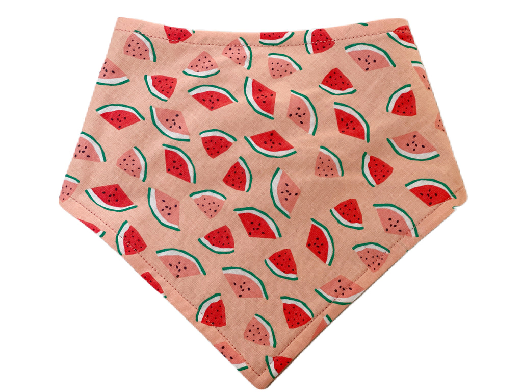 Handmade in Los Angeles dog and cat bandana. This bandana features a salmon pink background with red and pink watermelon slices. 3 snaps on the back for a secure and adjustable fit.