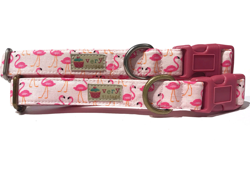 A close-up of the light pink collar, showcasing the playful flamingo pattern. Handmade from organic cotton and finished with antique brass or antique silver hardware, this collar is perfect for tropical summer days.