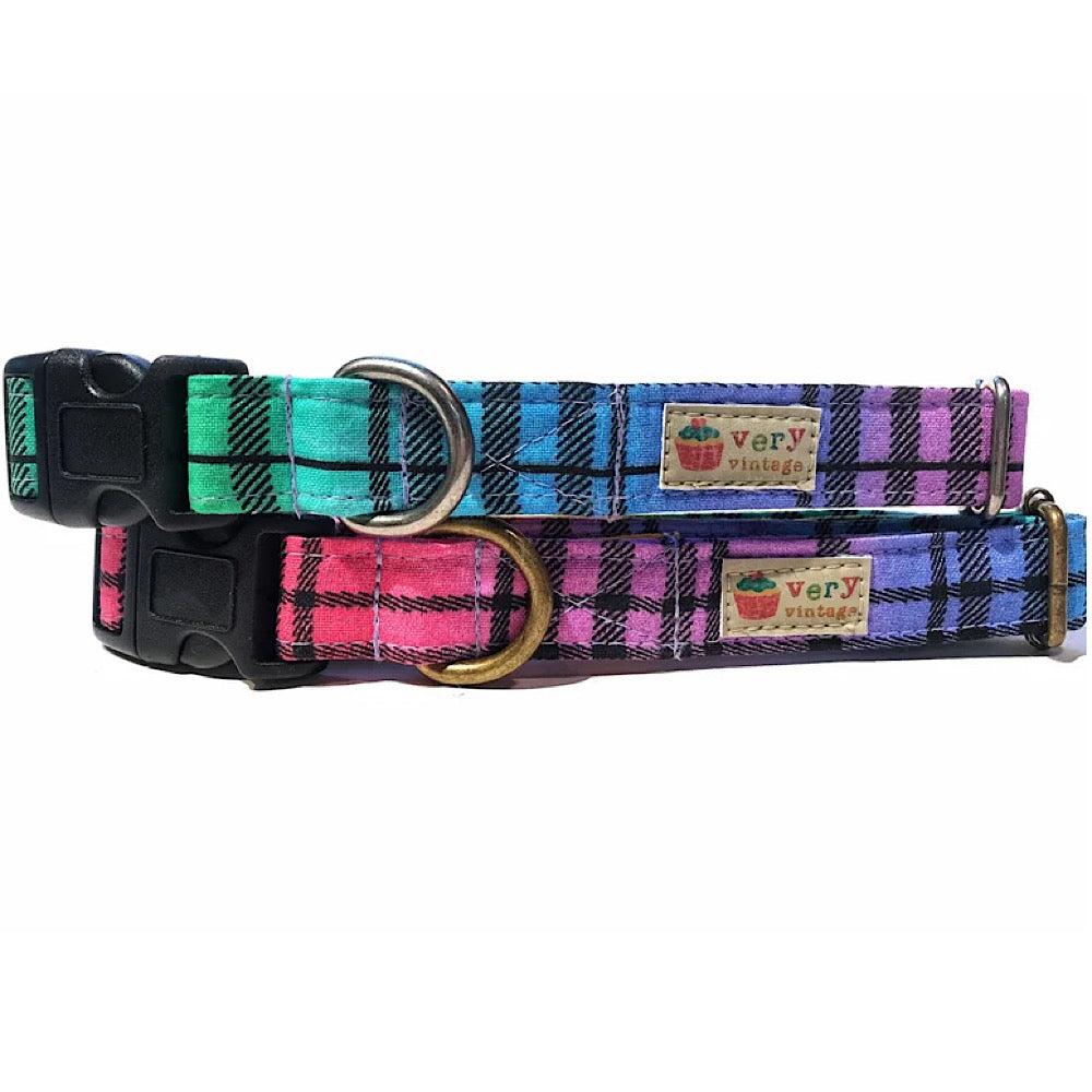 A close-up of the rainbow and black plaid collar, showcasing the colorful pattern with vibrant rainbow stripes and bold black checks. Available with antique brass or antique silver hardware. Handmade in Los Angeles.
