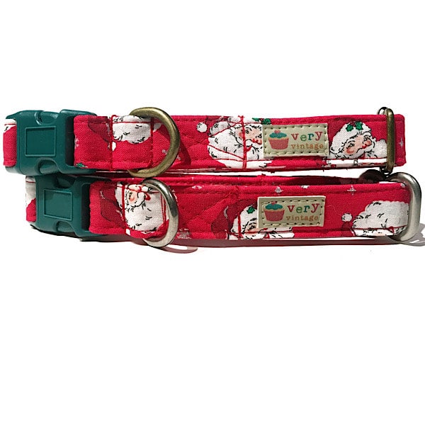 A close-up of the red collar with Santa heads, showcasing the festive holiday design. Available with antique brass or antique silver hardware, this collar adds a merry touch to your pet’s Christmas look.