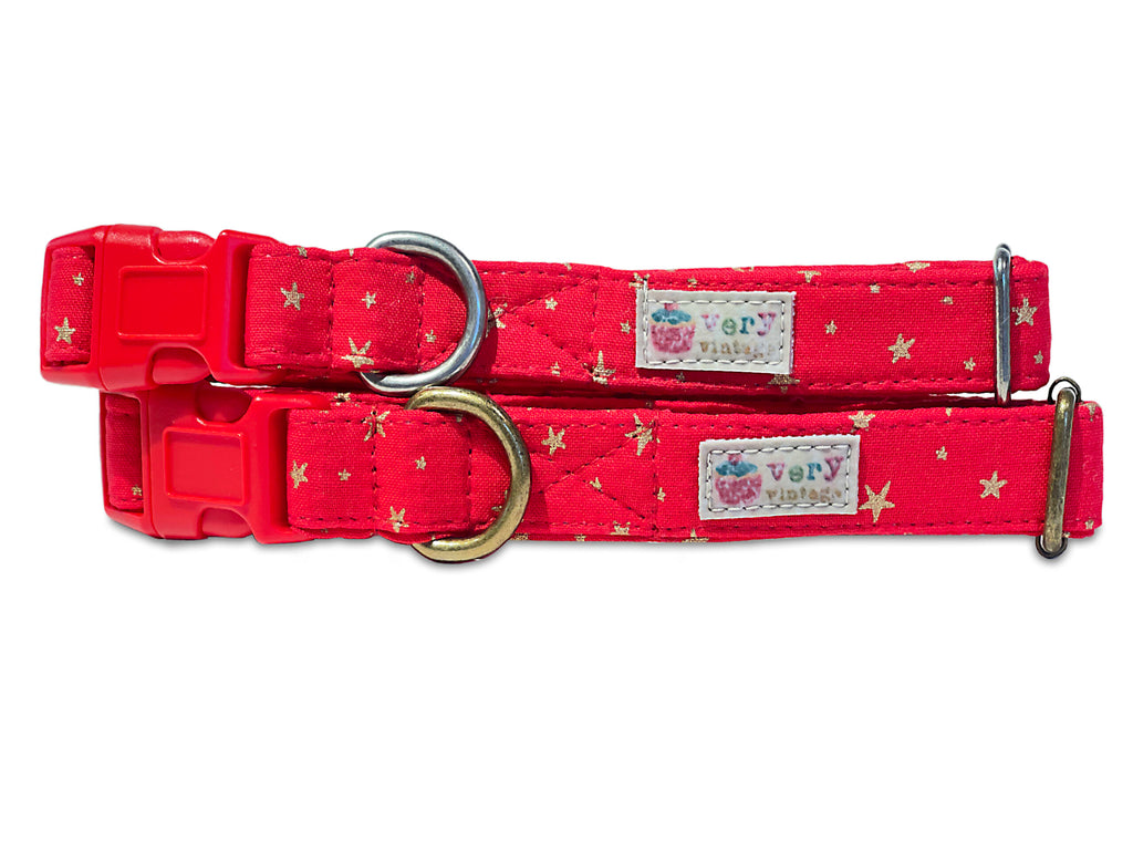 A close-up of the bright red collar with gold stars, showcasing the festive and magical design. Available with antique brass or antique silver hardware, this collar is perfect for Christmas and the holiday season. Cat collars come with safety and breakaway buckles. LA made.