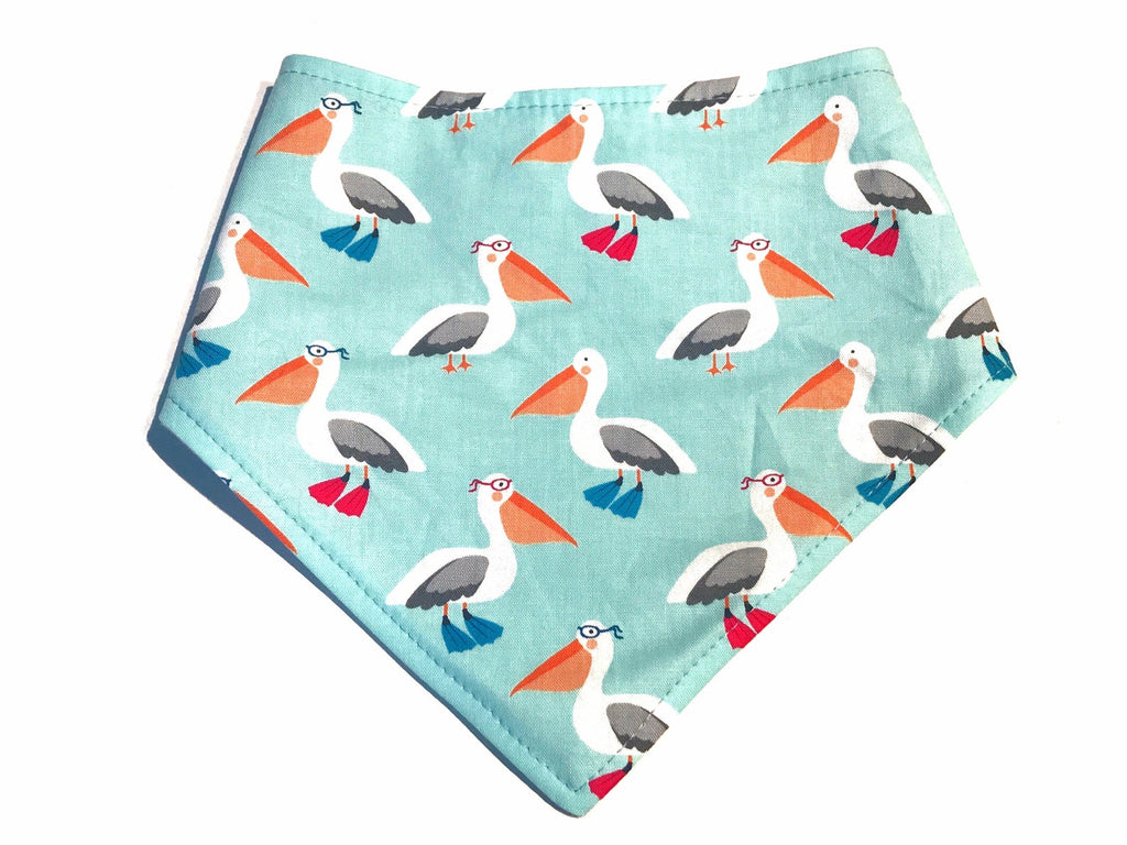 Handmade in Los Angeles. Organic cotton ice blue green background with cute pelican design. Very nautical! 3 snaps on back for an adjustable and secure fit.