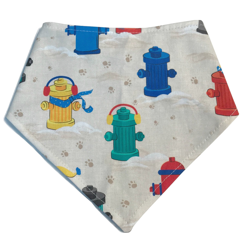 A cream dog bandana featuring a fun hydrant design, perfect for winter walks. Handmade in Los Angeles.